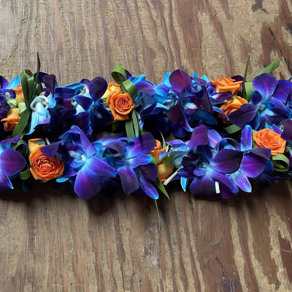 Purple and blue orchid garland with small orange roses