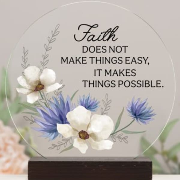 Round acrylic plaque with white and blue floral design and faith quote