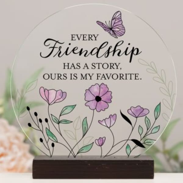 Round friendship plaque with purple flowers and a butterfly on a wooden base