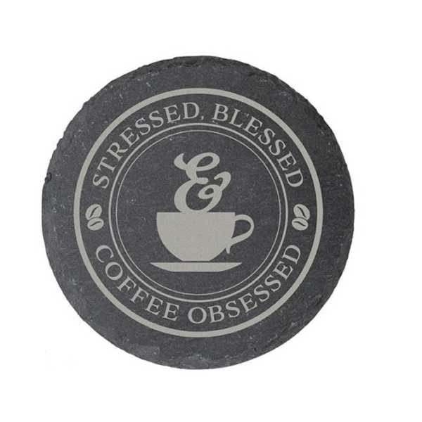 Round slate coaster with a coffee cup graphic and text
