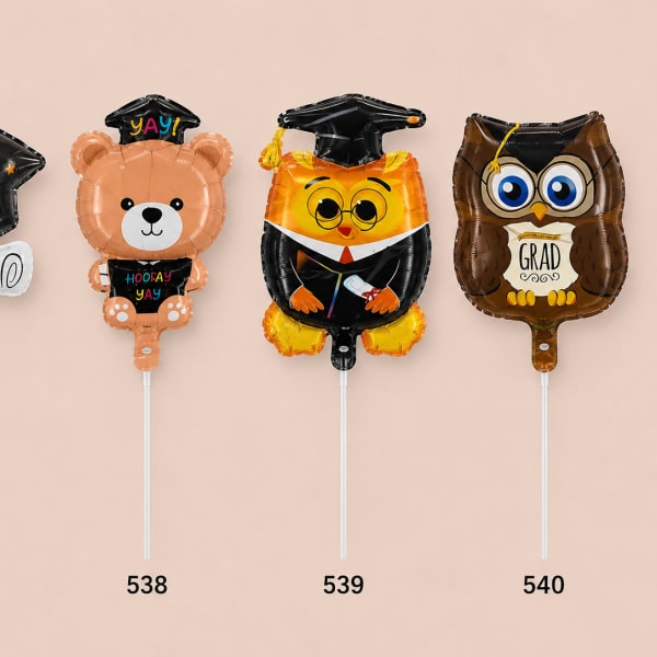 Four graduation-themed foil balloons shaped like a cap, bear, owl, and owl.
