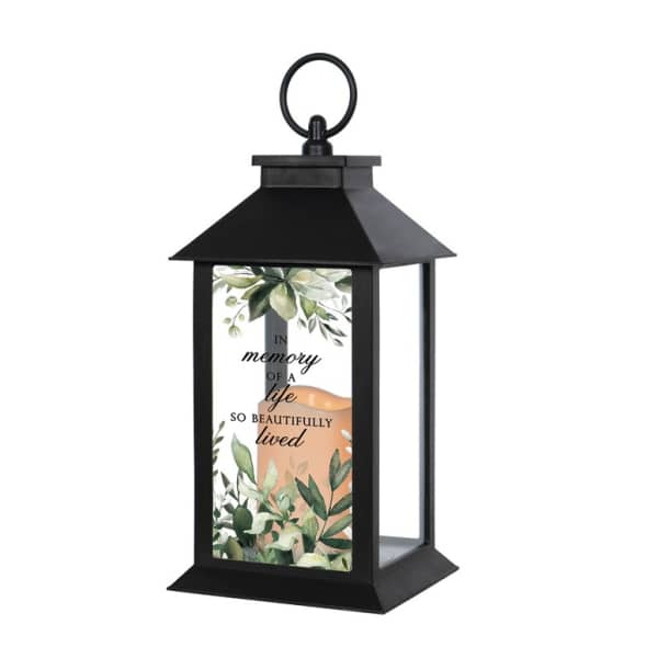 Black memorial lantern with leafy design and script text on the front panel