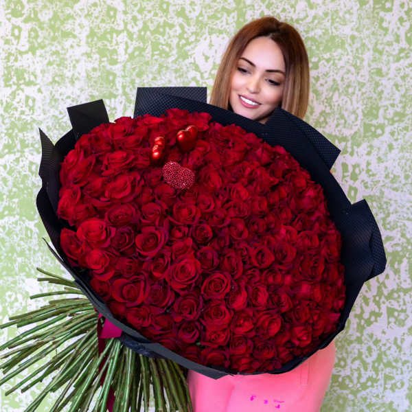 Large bouquet of red roses wrapped in black paper