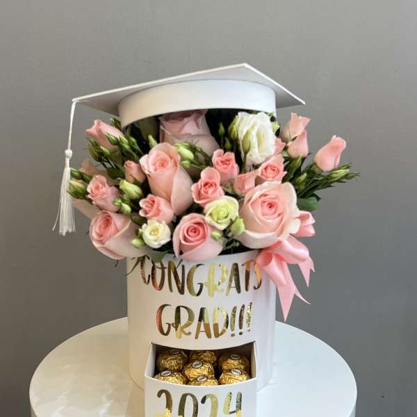 Pink rose bouquet in a white graduation box with chocolates