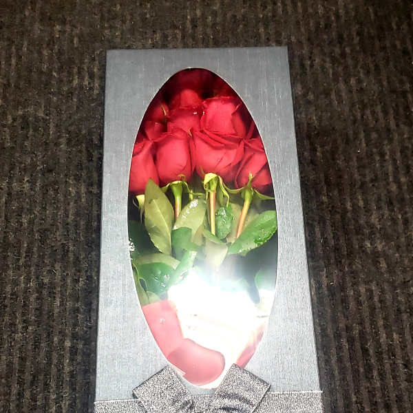 Box of red roses with a silver ribbon bow
