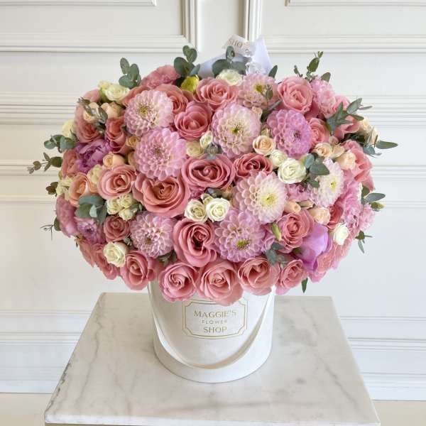 Large pink rose and dahlia arrangement in a white hatbox