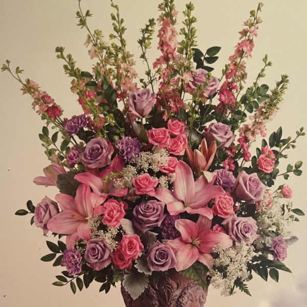 Pink and lavender floral arrangement in a decorative vase