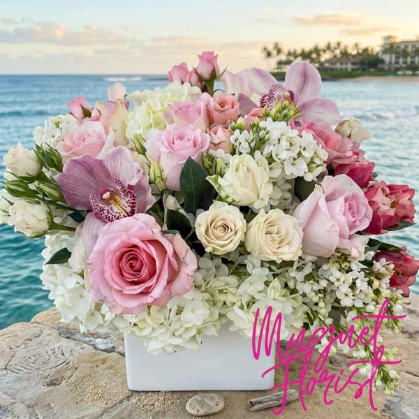 Pink and white rose bouquet with orchids and hydrangeas in a white vase