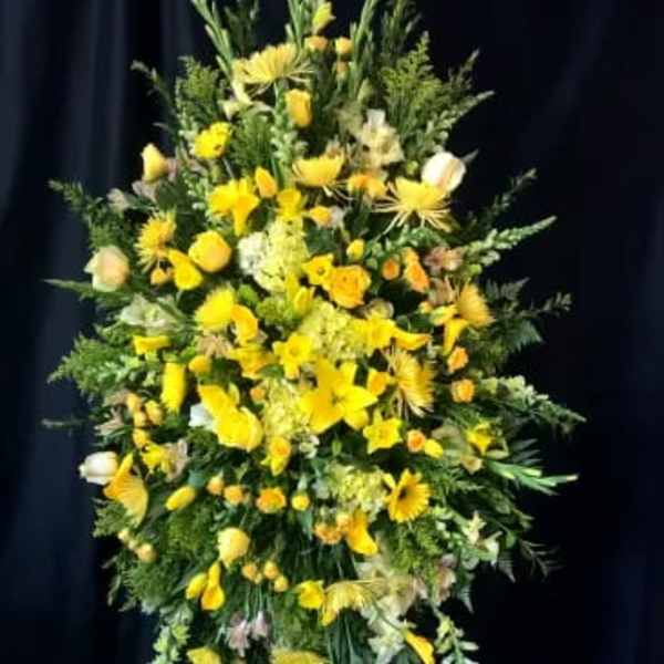 Tall yellow floral standing spray on an easel