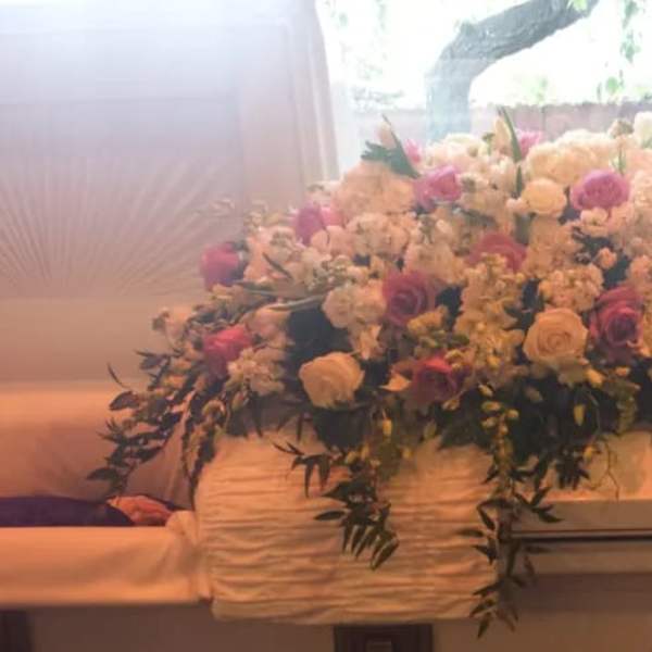 Large floral spray on a casket with pink and white flowers