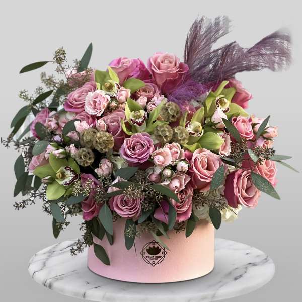 Pink rose bouquet in a round pink box with purple feathers