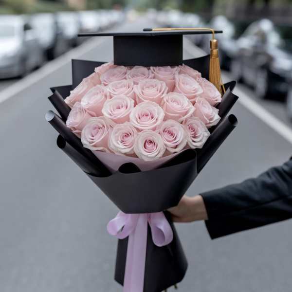 Pink rose bouquet with a graduation cap topper and ribbon