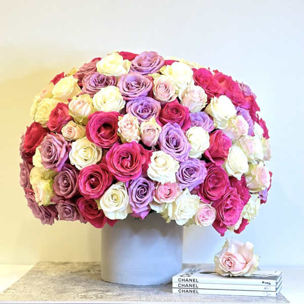 Large bouquet of multicolored roses in a gray vase