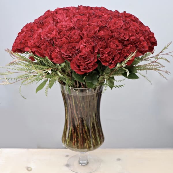 Red carnation bouquet in a clear glass vase