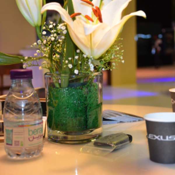 White lilies in a glass vase on a table