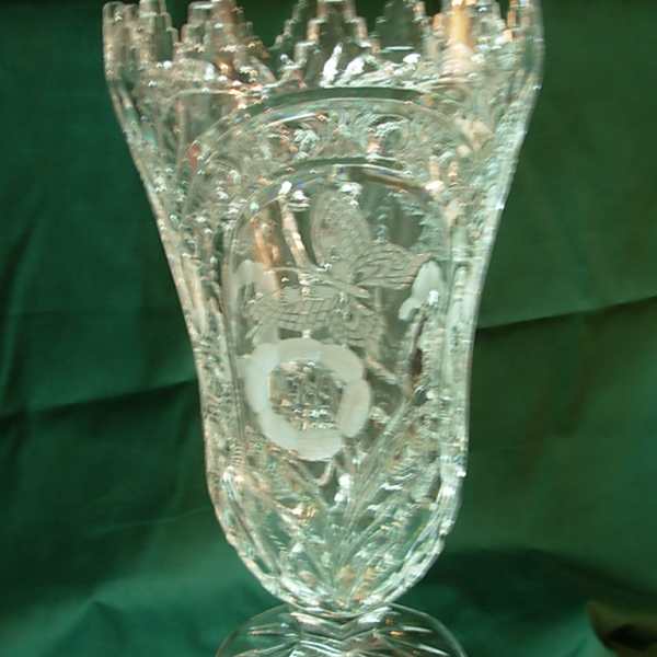 Ornate clear glass vase with a flared rim and pedestal base