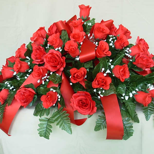 Red rose arrangement with red ribbons and greenery