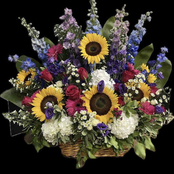 Large basket arrangement with sunflowers, roses, and mixed blooms