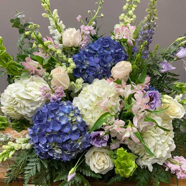 Large bouquet of blue hydrangeas, white roses, and pink alstroemeria