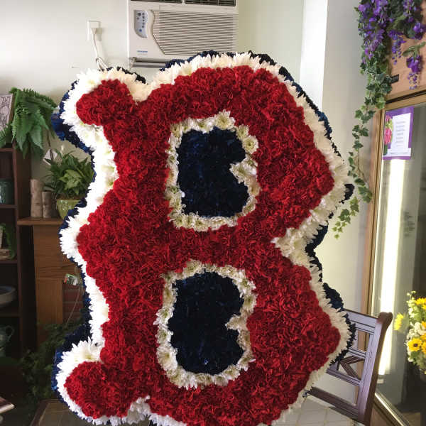 Large standing floral tribute shaped like the number 88 in red, white, and blue