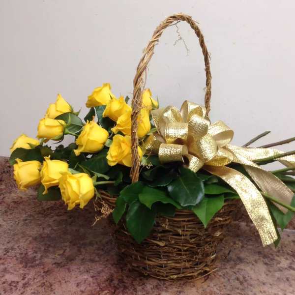 Basket of yellow roses with a gold ribbon bow