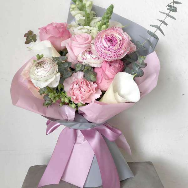Pink and white bouquet with roses, ranunculus, calla lilies, and snapdragons
