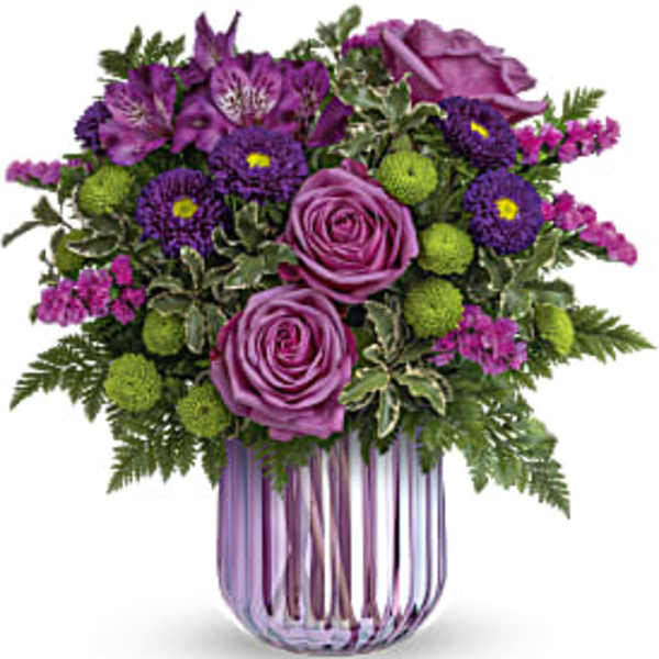 Purple roses and mixed purple flowers in a striped glass vase