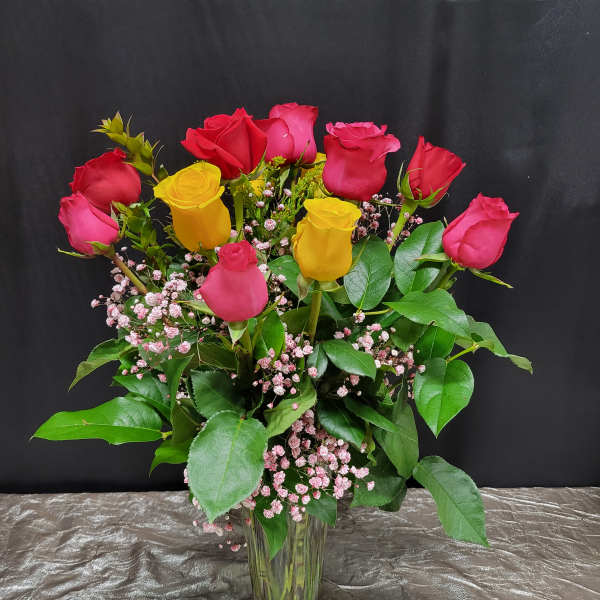 Bouquet of red and yellow roses in a glass vase