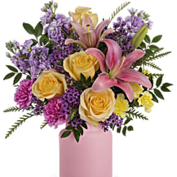 Pink lilies and yellow roses in a pink vase
