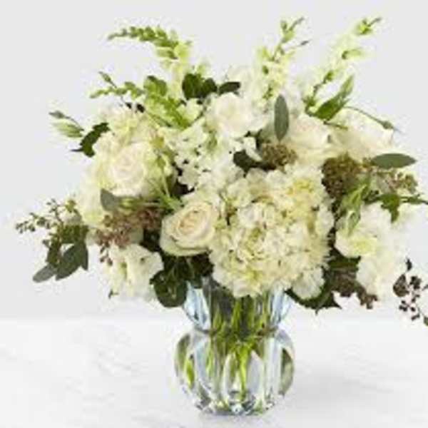 White floral bouquet in a clear glass vase