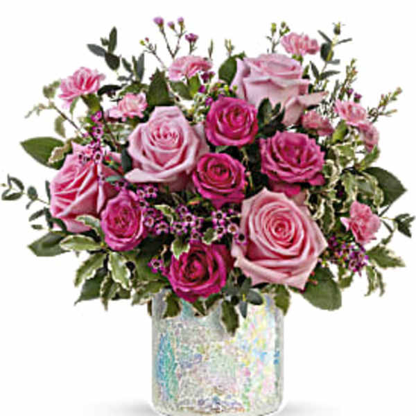 Pink and magenta roses in a clear vase