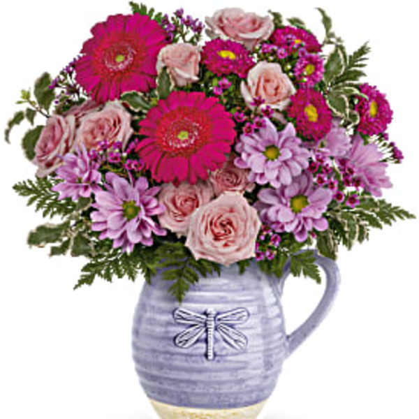 Pink and lavender mixed bouquet in a lavender ceramic pitcher vase