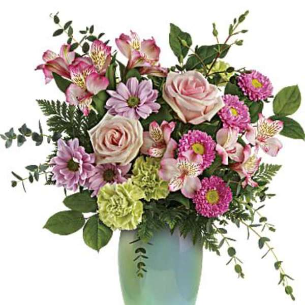 Pink and lavender flowers in a green vase