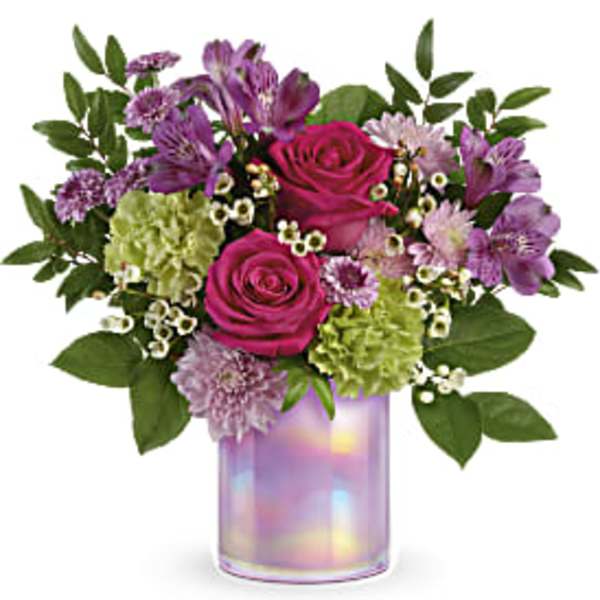 Bouquet of pink roses, purple alstroemeria, and green hydrangeas in a iridescent vase