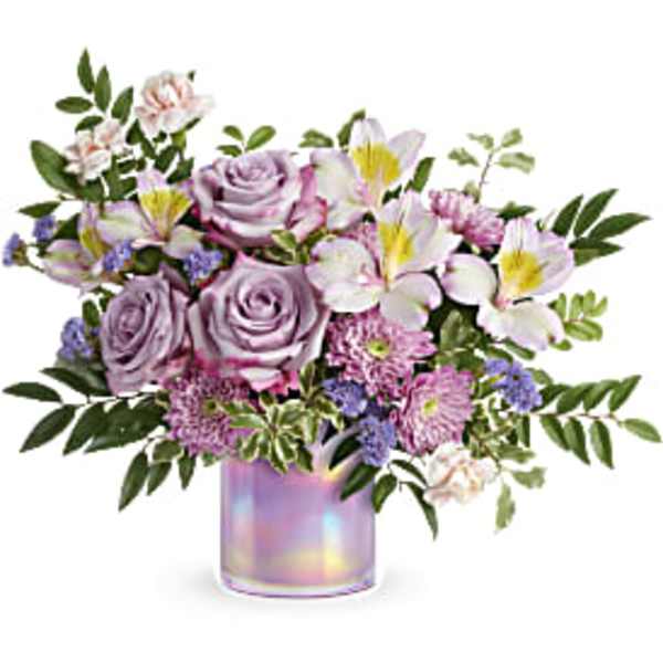 Lavender roses and lilies in an iridescent vase