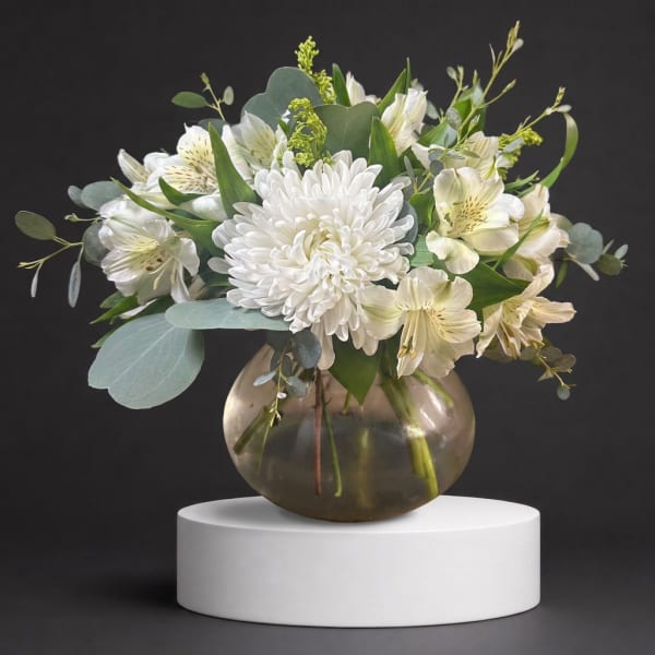 White chrysanthemum and alstroemeria arrangement in a round glass vase