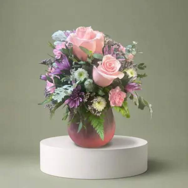 Pink and purple mixed bouquet in a glass vase