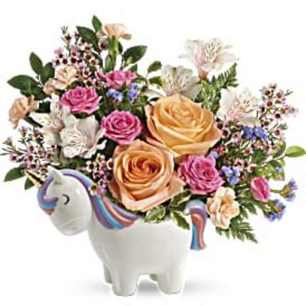 Bouquet of roses and mixed flowers in a unicorn-shaped vase