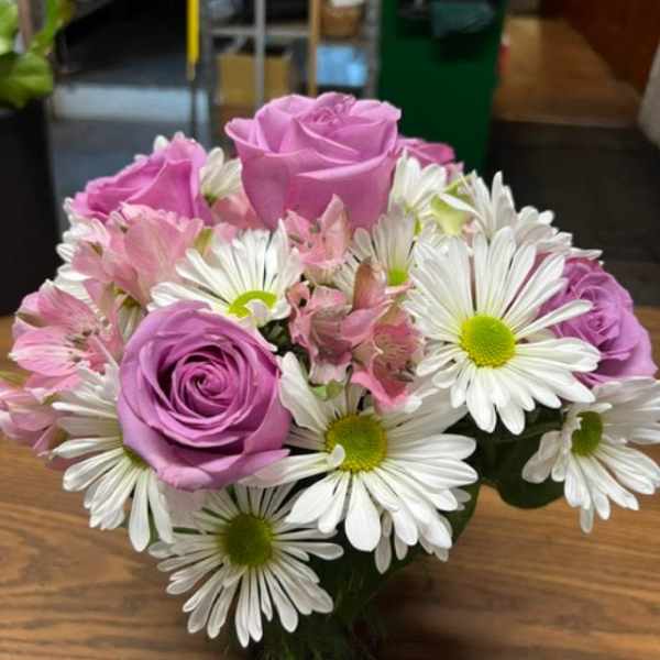 Pink roses and white daisies in a compact bouquet