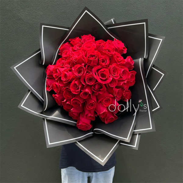 Large bouquet of red roses wrapped in black paper
