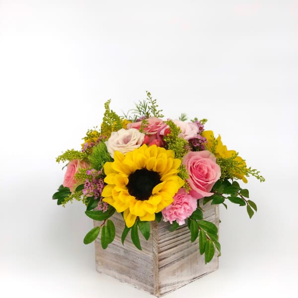 Sunflower and pink rose arrangement in a rustic wooden box