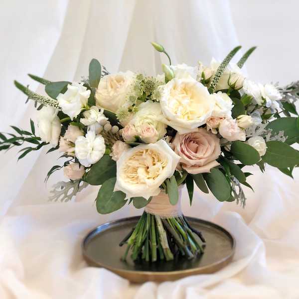 Cream and blush rose bouquet with greenery on a tray