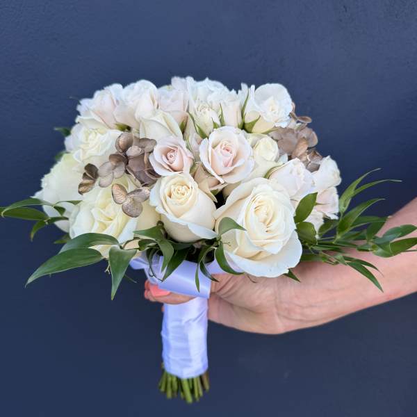 White and blush rose bridal bouquet with greenery and ribbon wrap