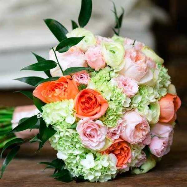 Bouquet of peach and pink roses with pale green hydrangeas