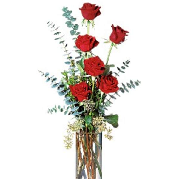 Tall arrangement of long-stem red roses with eucalyptus in a clear glass cylinder vase