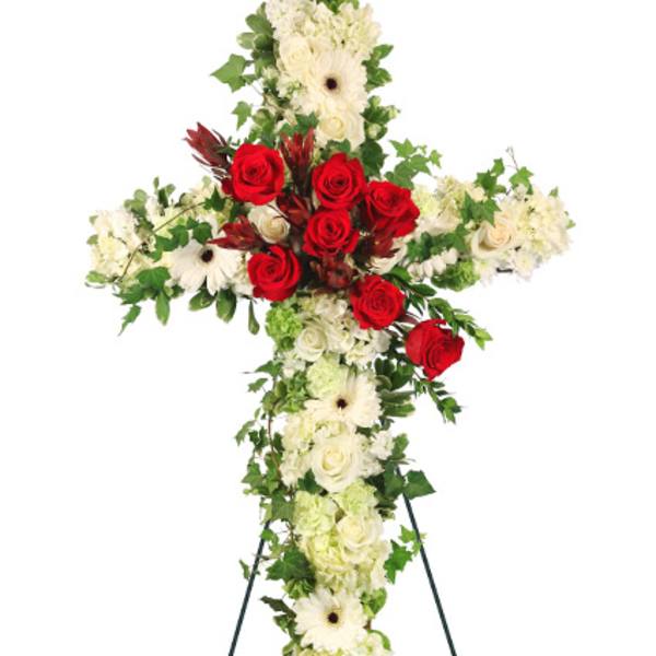Cross-shaped floral standing spray with red roses and white blooms