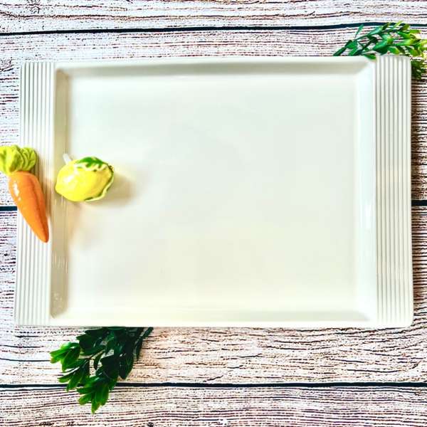 White rectangular serving tray with small vegetable decorations