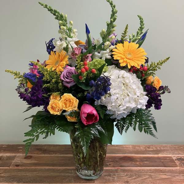Colorful mixed flower arrangement in a glass vase