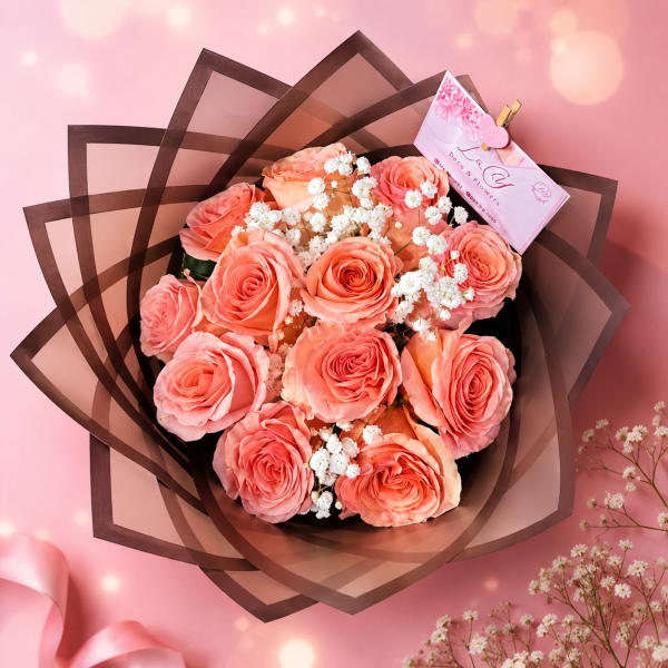 Bouquet of coral pink roses with white filler flowers in dark brown wrap