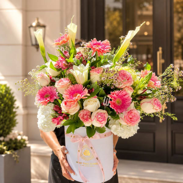 Pink and white mixed bouquet in a white hat box with a pink ribbon